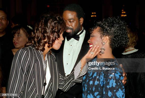 American singer and actress Whitney Houston and American R&B singer Gladys Night with husband William McDowell attend the Clive Davis Arista Records...