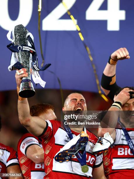 Lewis Ludlow of Gloucester lifts the Premiership Rugby Cup trophy following the final of the Premiership Rugby Cup between Gloucester Rugby and...