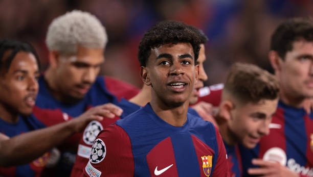 Lamine Yamal of FC Barcelona reacts as team mates celebrate with Fermin Lopez after he scored to give the side a 1-0 lead during the UEFA Champions...