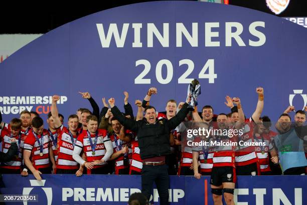 Former player Mark Atkinson lifts the trophy with Lewis Ludlow of Gloucester Rugby during the Premiership Rugby Cup Final between Gloucester Rugby...