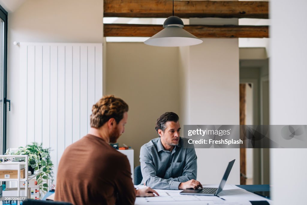 Two Professionals Engaged in a Business Discussion at a Modern Office