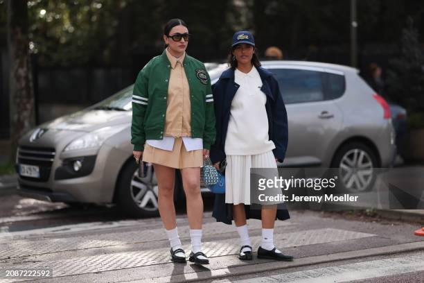 Guests seen wearing a green college jacket, brow blouse with white details, matching skirt, white socks and black leather shoes and shades and a...