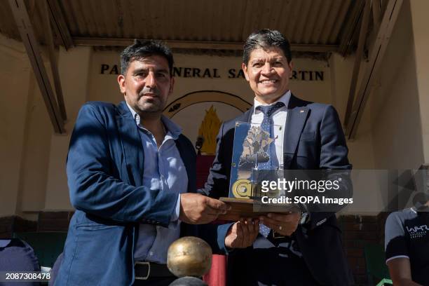The president of the Argentine Chamber of Medium-sized Companies Alfredo González presents an award to Pablo Segovia, president of the Argentine...