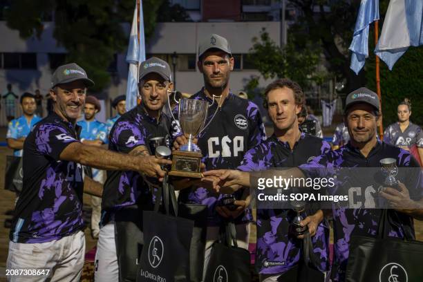 The Cavalier team, winners of the Open Horseball Argentina final, pose for a photo with their trophy at the Regimiento de Granaderos a Caballo. The...