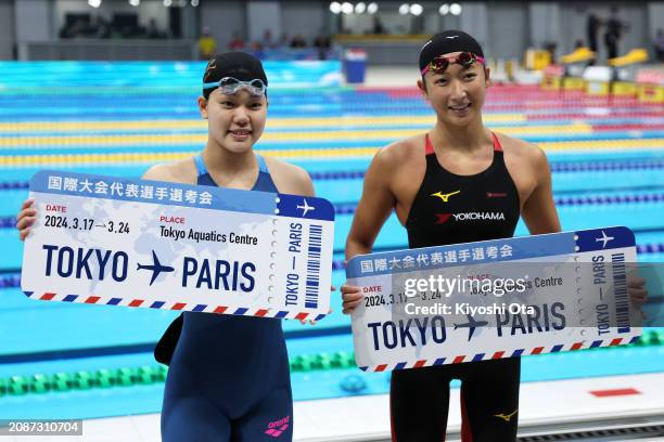 Mizuki Hirai and Rikako Ikee celebrate qualifying for the Paris 2024 Olympic Games after competing in the Women's 100m Butterfly Final during day two...