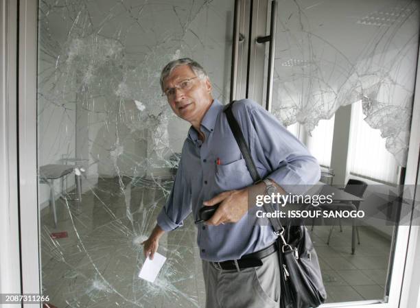 Herwig Kempf, director of the Goethe Institute, Germany's cultural center in Lome, shows bullet impacts at the devastated office in the Goethe...