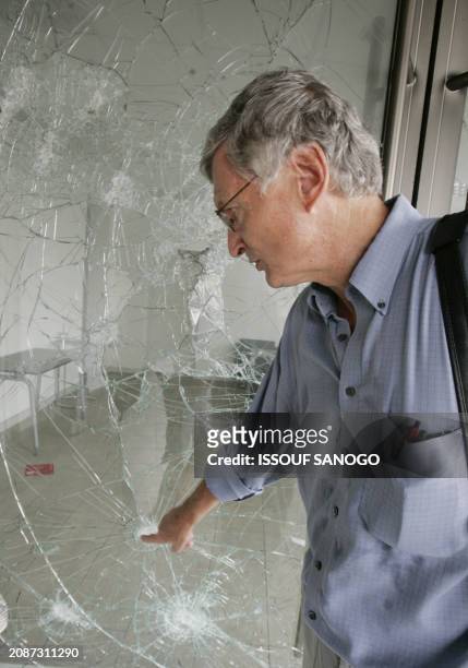 Herwig Kempf, director of the Goethe Institute, Germany's cultural center in Lome, shows bullet impacts at the devastated office in the Goethe...