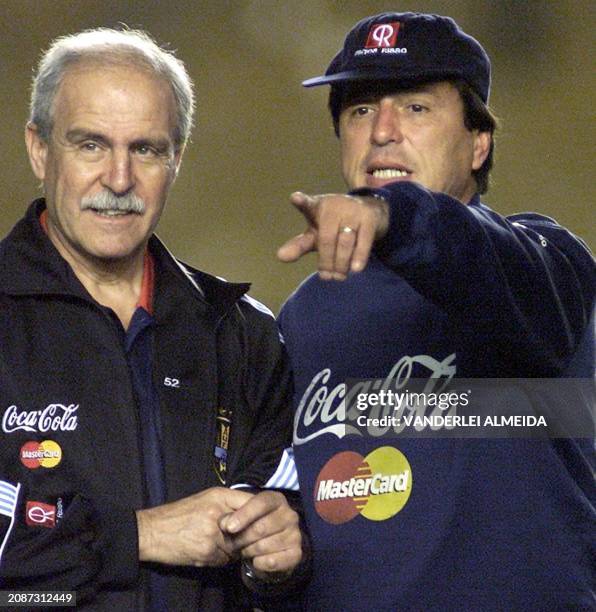 The technical director for Uruguay's select soccer team, Daniel Passerella talks to the team's medic, Eduardo Voituret, during a practice in Maracana...