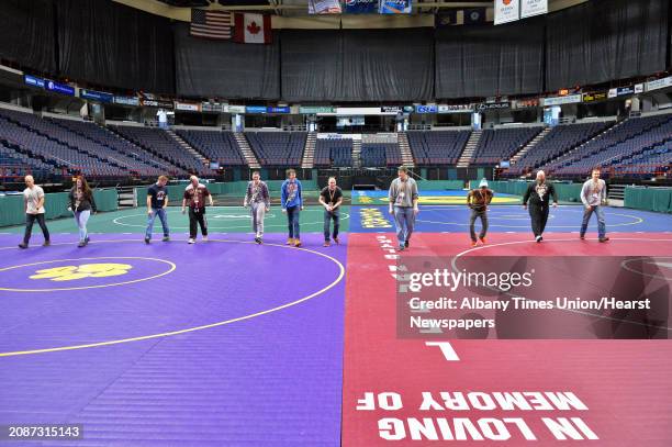 Crew from South Glens Falls checks the placement of mats for the 2016 NYSPHSAA Wrestling Championships at the Times Union Center Thursday Feb. 25,...