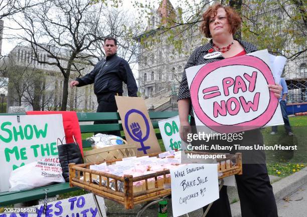 Laurel Young, at right, of Occupy Albany holds a gender neutralizing bake sale to protest pay inequity and gender discrimination on the east lawn of...