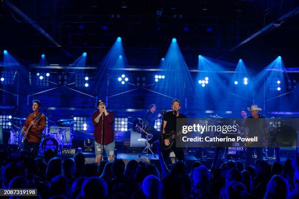 Ryan Peake of Nickelback, HARDY, and Chad Kroeger and Mike Kroeger of Nickelback perform at CMT Crossroads: Nickelback & HARDY at Marathon Music...