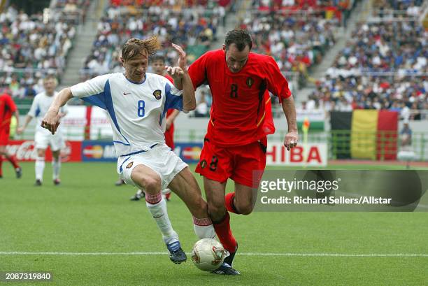 June 14: Valery Karpin of Russia and Bart Goor of Belgium challenge during the FIFA World Cup Finals 2002 Group H match between Belgium and Russia at...