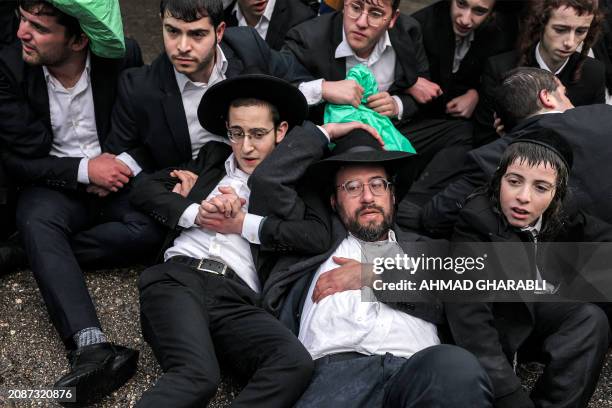 Ultra-orthodox Jewish protesters assemble for a protest against their conscription into the Israeli armed forces, in Jerusalem on March 18, 2024 amid...