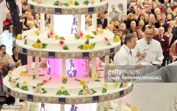 Berlin Mayor Klaus Wowereit and KaDeWe Managing director Patrice Wagner have a piece of a giant cake during the 100th birthday of Berlin's KaDeWe...