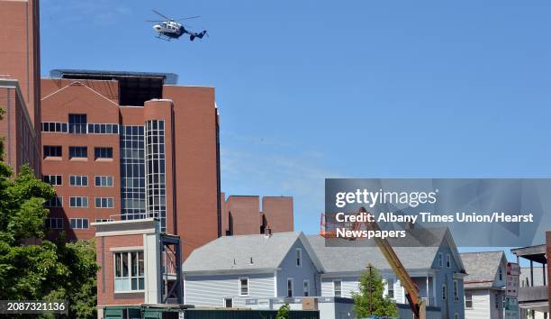 Helicopter flies over Myrtle Avenue to land atop Albany Medical Center on New Scotland Avenue in the city's Park South neighborhood in Albany, NY,...