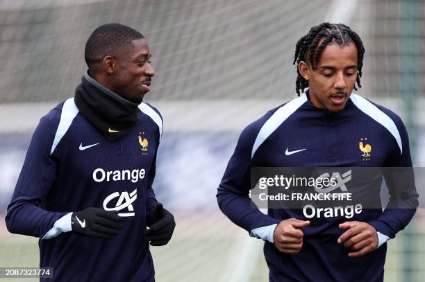 France's forward Ousmane Dembele and France's defender Jules Kounde attend a training session as part of the team's preparation for the upcoming...