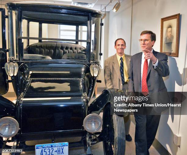 Union College President Stephen C. Ainlay, right, and engineering professor John Spinelli look over the 1914 "Duplex Drive Brougham" Detroit Electric...