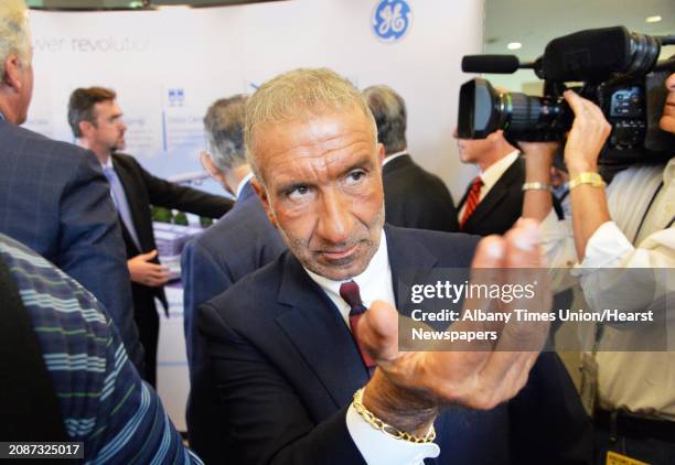 Albany Nanocollege CEO Alain Kaloyeros calls to an associate during the announcement of a new $500 million power electronics manufacturing consortium...