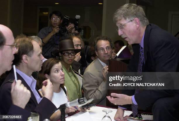 Director of the National Institute of Health's National Genome Research Francis Collins speaks with reporters after a press conference 26 June 2000...