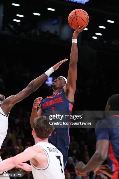 Jimmy Clark III of the Duquesne Dukes shoots the ball during the Atlantic 10 Tournament Championship game against the Virginia Commonwealth Rams on...