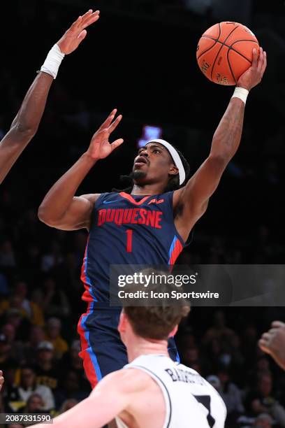 Jimmy Clark III of the Duquesne Dukes shoots the ball during the Atlantic 10 Tournament Championship game against the Virginia Commonwealth Rams on...