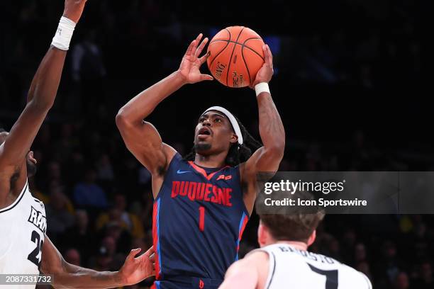 Jimmy Clark III of the Duquesne Dukes shoots the ball during the Atlantic 10 Tournament Championship game against the Virginia Commonwealth Rams on...