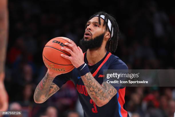 Dae Dae Grant of the Duquesne Dukes controls the ball during the Atlantic 10 Tournament Championship game against the Virginia Commonwealth Rams on...