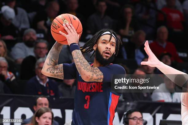 Dae Dae Grant of the Duquesne Dukes controls the ball during the Atlantic 10 Tournament Championship game against the Virginia Commonwealth Rams on...