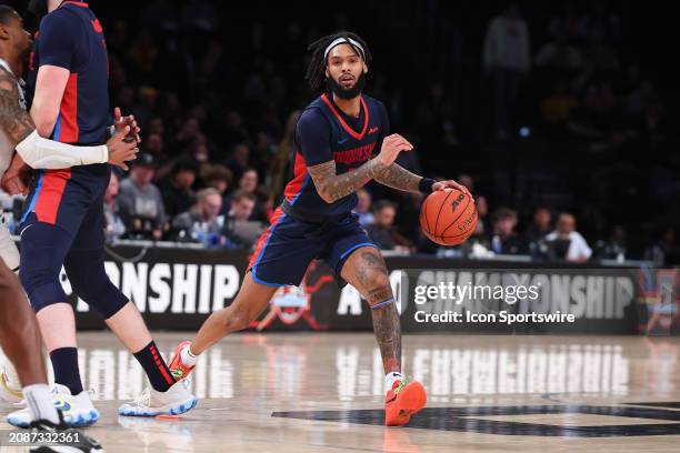 Dae Dae Grant of the Duquesne Dukes controls the ball during the Atlantic 10 Tournament Championship game against the Virginia Commonwealth Rams on...