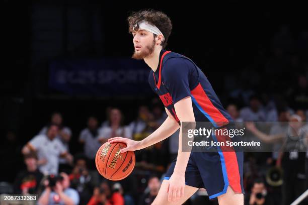 Jake DiMichele of the Duquesne Dukes controls the ball during the Atlantic 10 Tournament Championship game against the Virginia Commonwealth Rams on...