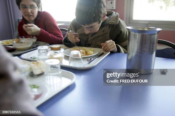 Young handicaped kids take their lunch break at Emmanuel de Martonne school in Laval 02 December 2005 where handicaped kids share their breaks, lunch...