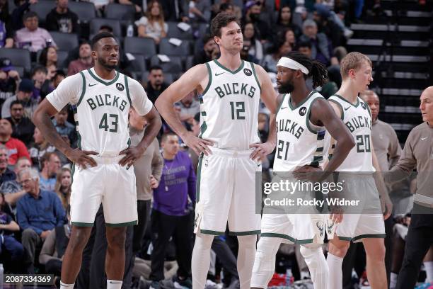 Thanasis Antetokounmpo, Danilo Gallinari, and Patrick Beverley of the Milwaukee Bucks look on during the game against the Sacramento Kings on March...