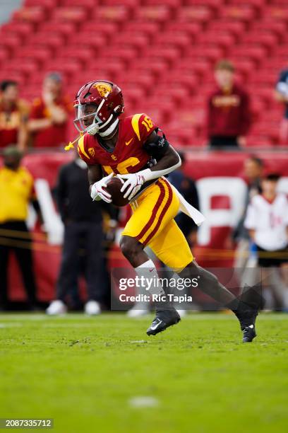 Tahj Washington of the USC Trojans runs after the catch during a game against the UCLA Bruins at United Airlines Field at the Los Angeles Memorial...