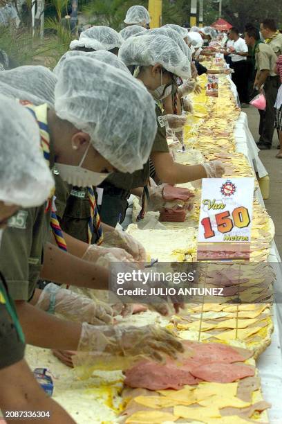 Some three hundred boys scouts make the largest sandwich in Latin America, 23 March 2003 in Tegucigalpa. The sandwich measures 150 meters in length...