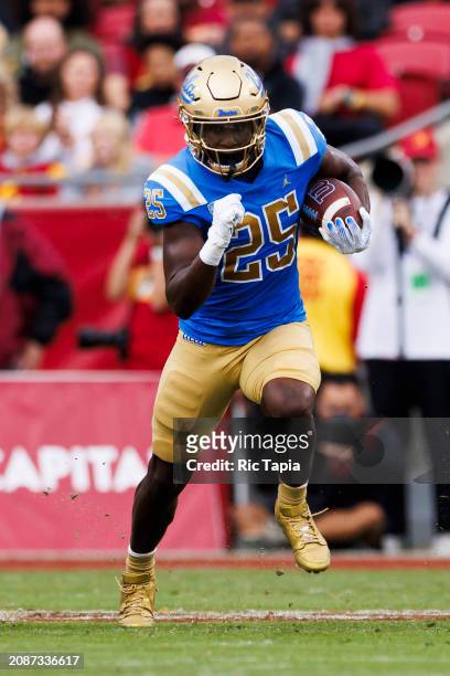 Ezavier Staples of the UCLA Bruins runs after the catch during a game against the USC Trojans at United Airlines Field at the Los Angeles Memorial...