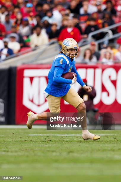 Ethan Garbers of the UCLA Bruins runs with the ball during a game against the USC Trojans at United Airlines Field at the Los Angeles Memorial...