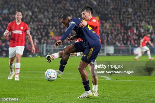 Joshua Brenet of FC Twente, Hirving Lozano of PSV during the Dutch Eredivisie match between PSV v Fc Twente at the Philips Stadium on March 17, 2024...