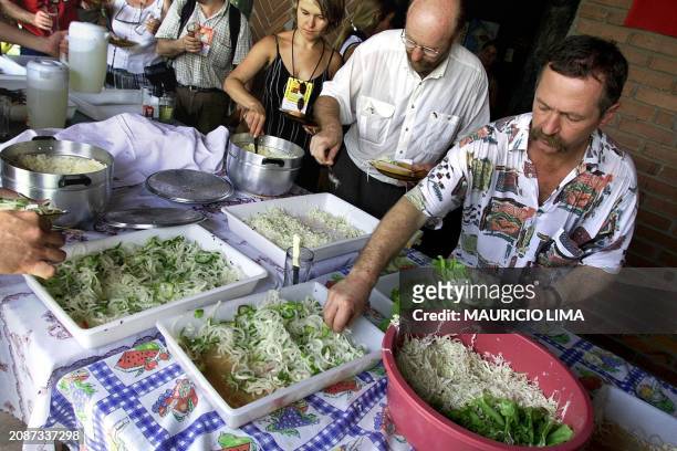 French activist Jose Bove is seen getting salad during lunch in Rio Grande del Sur, Brazil 28 January 2001. Jose Bove , lider campesino frances y...