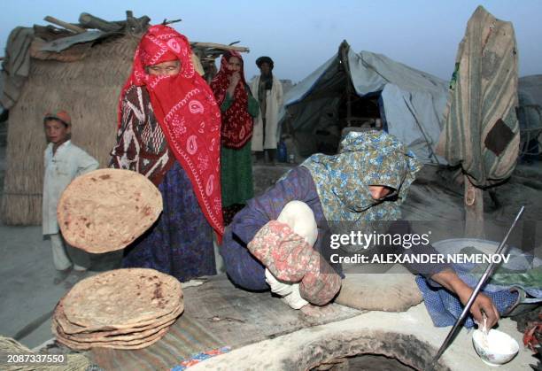 Afghan refugees bake bread in a refugee camp not far from the village of Khaga Bawden, northern Afghanistan, some 15km from the Tajik border, 22...