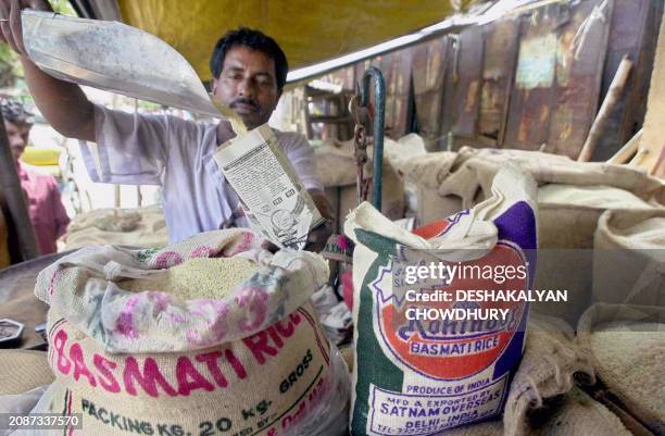 Rice vendor Ratan Das fills a small paper packet with Basmati rice in Calcutta 23 August 2001. The Indian government attempted to quell the uproar...