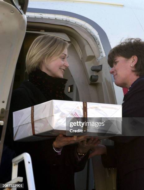 Unidentified guests carry one of five boxes containing the wedding cake upon arrival at Kinloss RAF base in Scotland for the wedding of popstar...