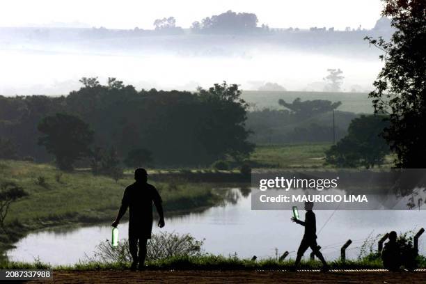 Two members of the Country Workers Without Land Movement, look for water before a demonstration against the American seeds manufacture, Monsato, in...