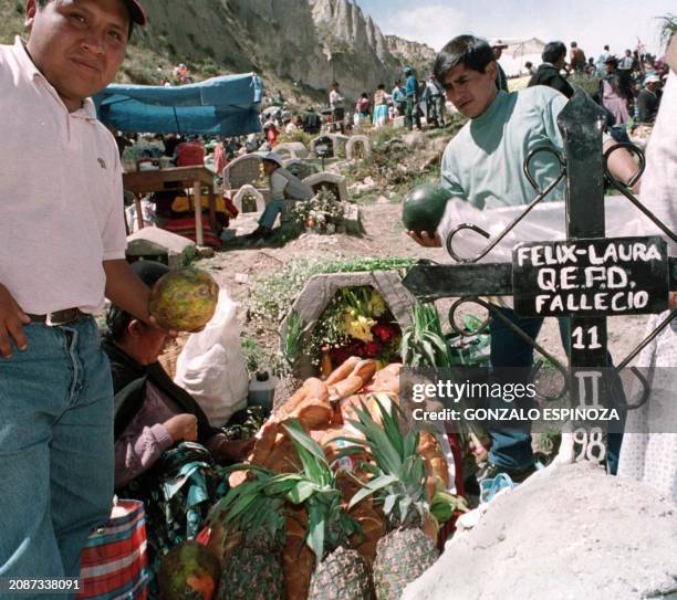 Relatives of a dead pile up fruits on the tomb 02 November 2000 in a cemetery in La Paz, Bolivia, in the belief that spirits of the dead share those...