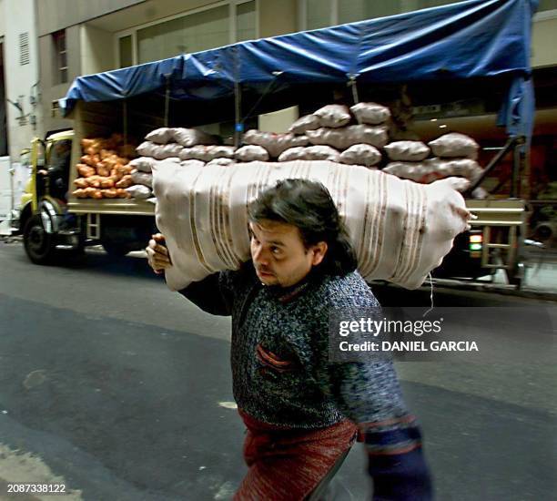 Worker loads bags of potatos to a restaurant in Buenos Aires, Argentina, 04 October 2000. This is a fourth day of truck drivers' strike in the...