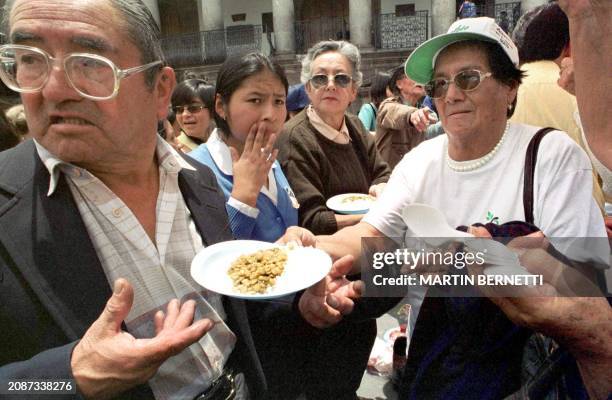 Woman activist of Human Rights organizations in Ecuador preapared plates of food that she passed out in front of the presidency in the Republic of...