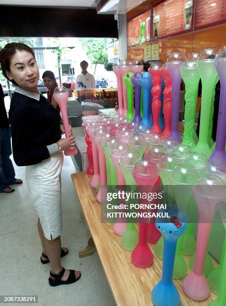 Thai teenager chooses a fantasy milkshake cup, 22 May 2000, at an ice cream parlor in the Thai capital. Thai and foreign ice cream companies...