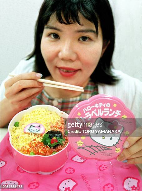 An identified woman is about to eat a boxed lunch showing "Hello Kitty", popular character from creator Japan's Sanrio Co. Ltd., in Tokyo 23 August....