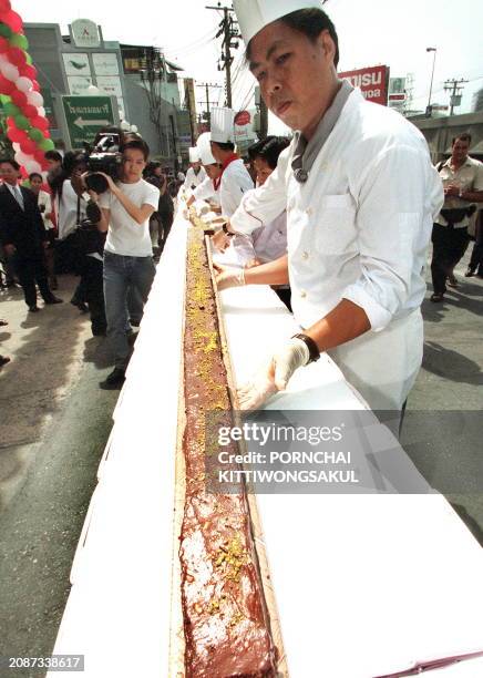 Thai chefs assemble the world's longest brownie, 26 August 1999. The brownie, measuring 60 meters long and four centimeters thick, was prepared by 20...