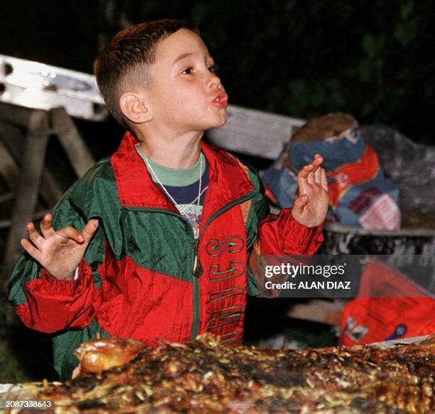 Elian Gonzalez reacts after tasting the roast pig at the Christamas Eve dinner at the home of his relatives in Miami, FL, 24 December, 1999. Elian,...