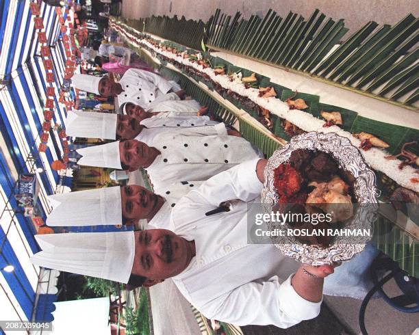 Malay chef 13 July, stands with his team-mates while displaying one of a dish along the 239-feet long stretch of "Nasi Padang" cuisine, rice with 39...